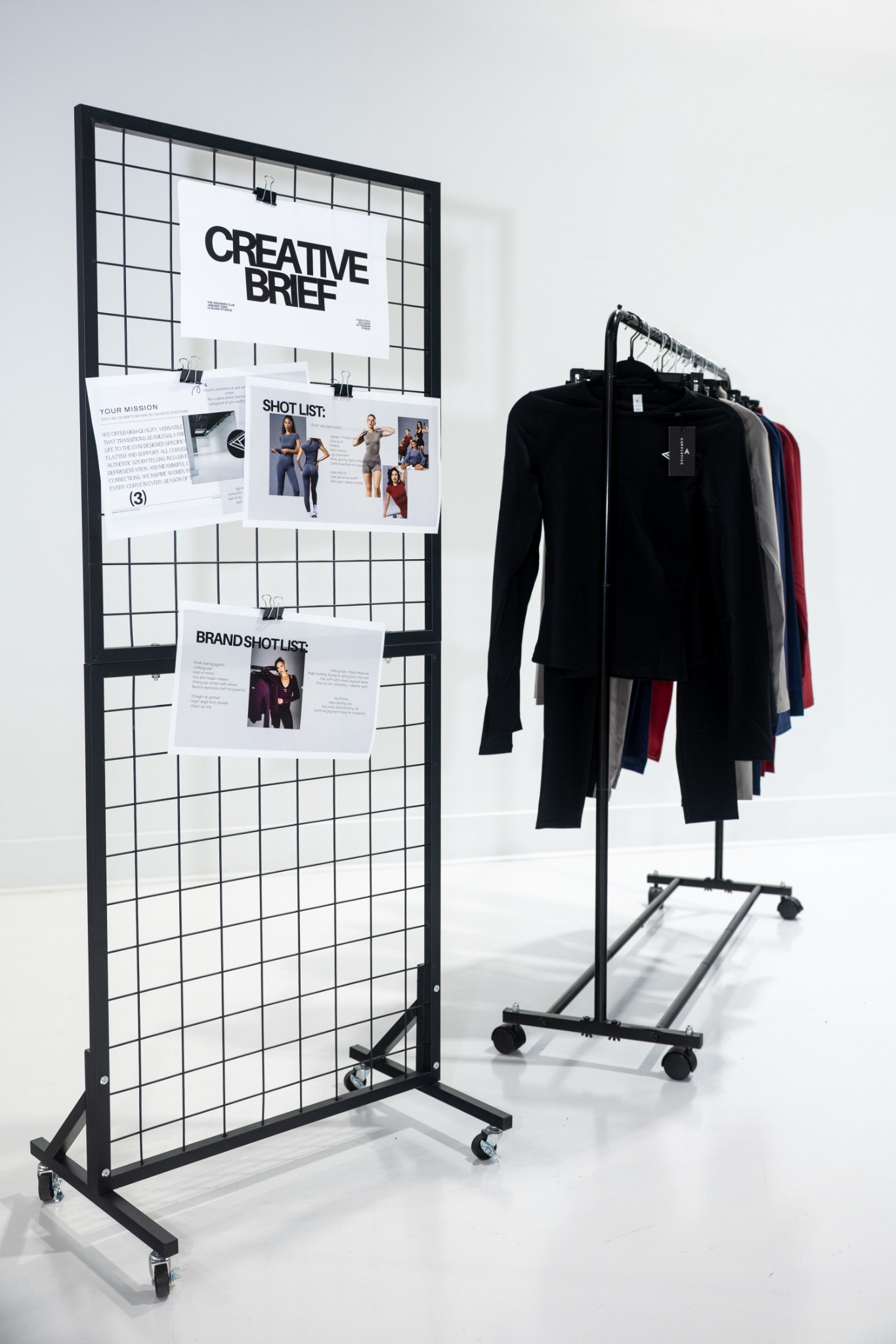 Creative brief and Curvletics clothing rack on set